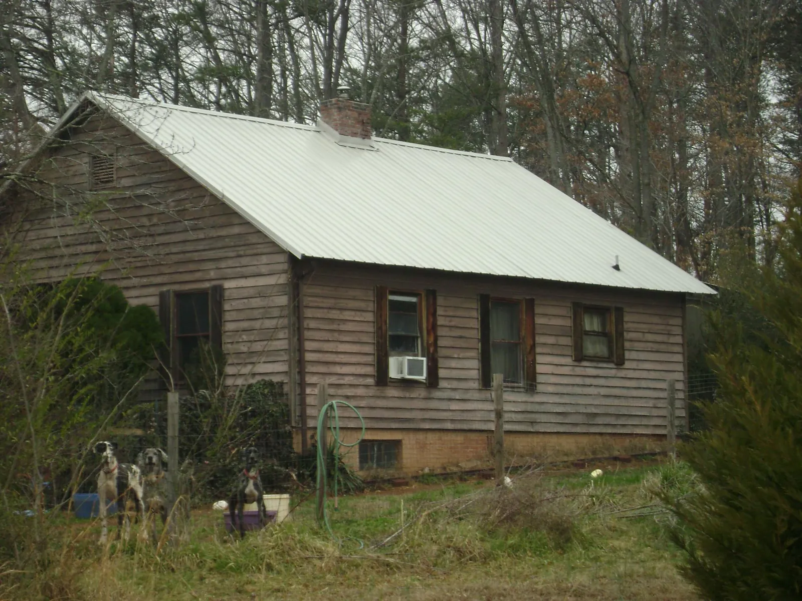 White metal roof on an old wood sided farmhouse, from a Metal Roof Installation job in Hingham